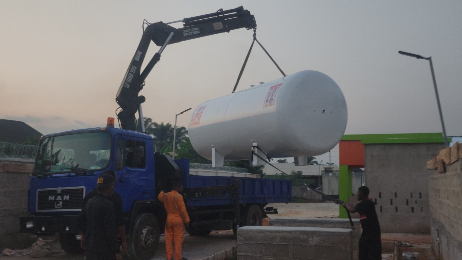 Crane lifting an LPG storage tank into place